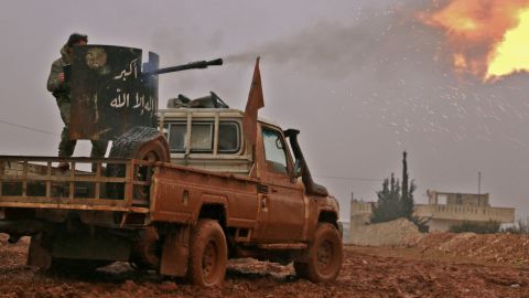Syrian opposition fighters fire towards positions held by Islamic State group jihadists in al-Bab on the northeastern outskirts of the northern embattled city of Aleppo on December 13.