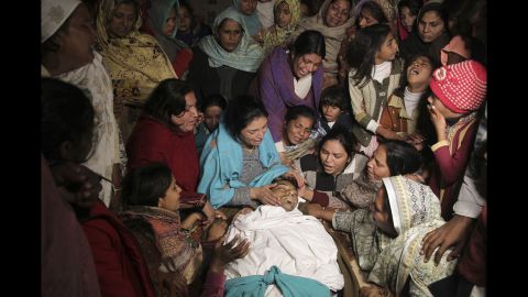 <strong>December 28:</strong> Women mourn the death of a family member in Toba Tek Singh, Pakistan. Local police said dozens of people were killed and many transported to hospitals after they consumed contaminated alcohol during the Christmas holidays. 