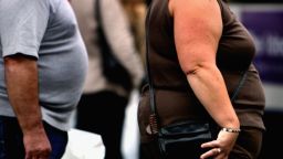 An overweight person walks through Glasgow city center on October 10, 2006 in Glasgow, Scotland. According to government health maps, people in the north of England lead less healthy lifestyles compared to those in the south. 