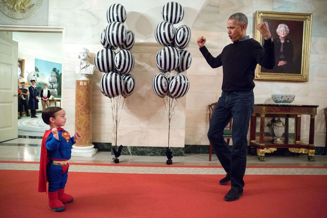 "The President was about to welcome local children for Halloween trick-or-treating when he ran into Superman Walker Earnest, son of Press Secretary Josh Earnest, in the Ground Floor Corridor of the White House. 'Flex those muscles,' he said to Walker." (Official White House Photo by Pete Souza)