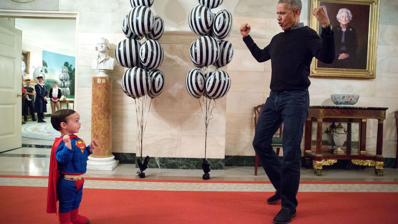 "The President was about to welcome local children for Halloween trick-or-treating when he ran into Superman Walker Earnest, son of Press Secretary Josh Earnest, in the Ground Floor Corridor of the White House. 'Flex those muscles,' he said to Walker." (Official White House Photo by Pete Souza)