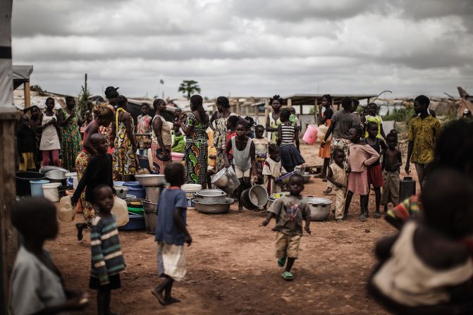 Life inside the camp can be hard with many having lost their jobs or livelihoods. Pictured: People waiting for daily water distribution at a camp in Bangui, Central African Republic, in November 2015.