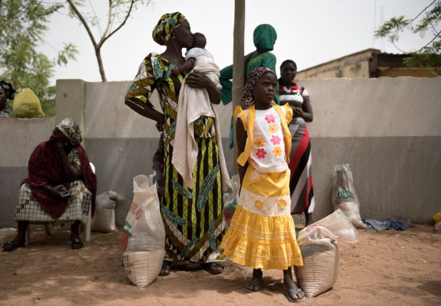 In Nigeria, conflict and violence caused by the Boko Haram insurgency make up more than 90 percent of displacements, according to IOM. Pictured: displaced Nigerians at a distribution center.