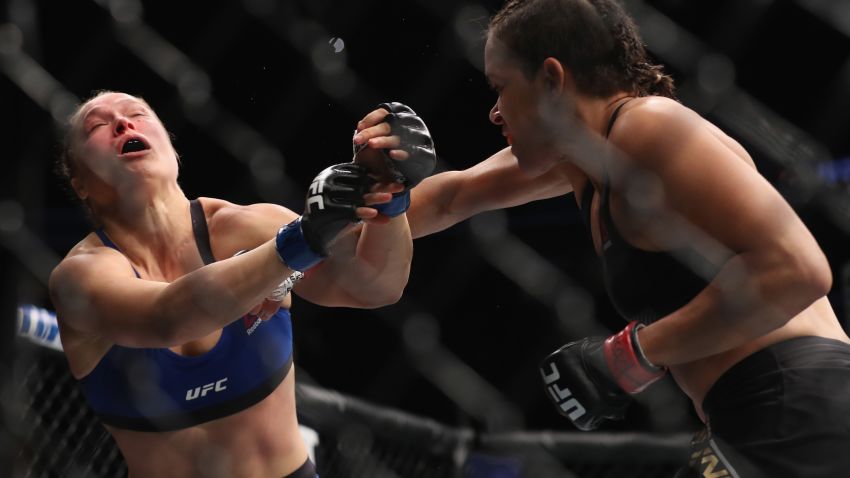 LAS VEGAS, NV - DECEMBER 30: (R-L) Amanda Nunes of Brazil punches Ronda Rousey in their UFC women's bantamweight championship bout during the UFC 207 event on December 30, 2016 in Las Vegas, Nevada.  (Photo by Christian Petersen/Getty Images)