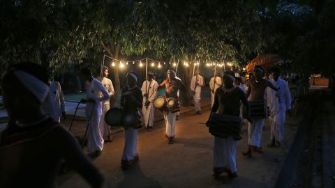Sri Lankan Buddhist devotees carry various offerings at a temple on New Year's Eve in Colombo, Sri Lanka.