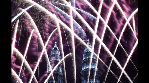 Fireworks illuminate the sky near the Petronas Twin Towers in Kuala Lumpur, Malaysia.