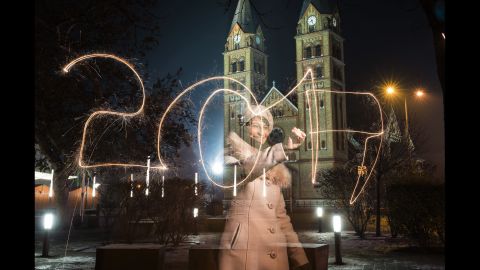 A woman writes "2017" using a sparkler during New Year's Eve celebrations in Nyiregyhaza, Hungary.