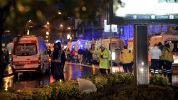 Medics and security officials work at the scene after an attack at a popular nightclub in Istanbul, early Sunday, Jan. 1, 2017. Turkey's state-run news agency said an armed assailant has opened fire at a nightclub in Istanbul during New Year's celebrations.(IHA via AP)