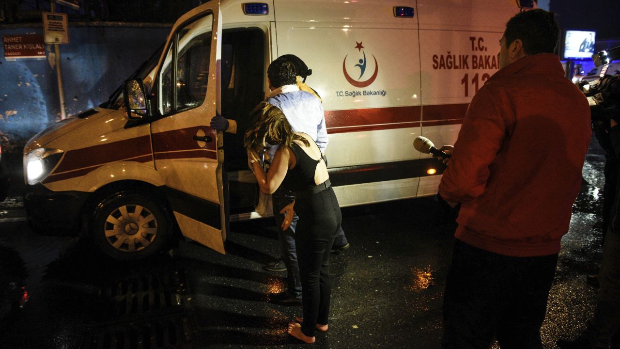 A wounded person is put into an ambulance.