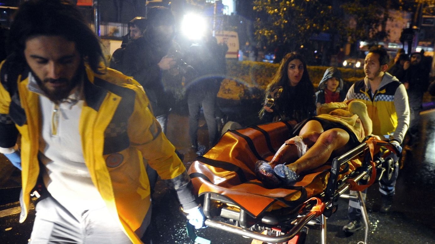 A wounded victim is rushed from the scene.