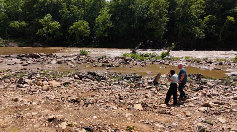 Korey Hampton walks on the banks of the French Broad River in Marshall. This area was lined with mature trees when the floodwaters roared down from Asheville to the north and washed them away.