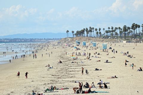 People visit the beach in Huntington Beach, California, on March 21.