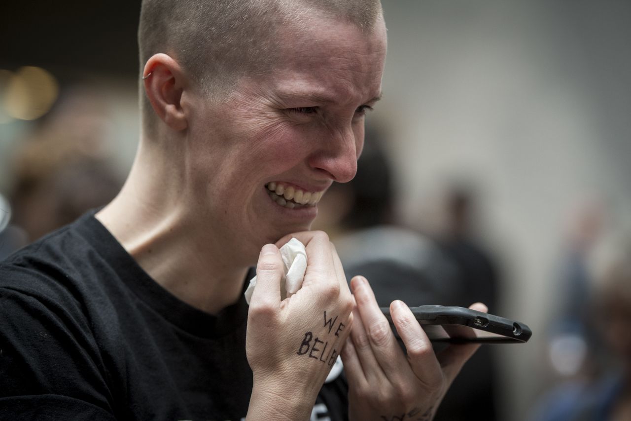 Joy Gerhard, of Seattle, cries in the Hart Senate Office Building atrium as she listens on her phone to Dr. Christine Blasey Ford testify about the alleged sexual assault by Supreme Court nominee Brett Kavanaugh.