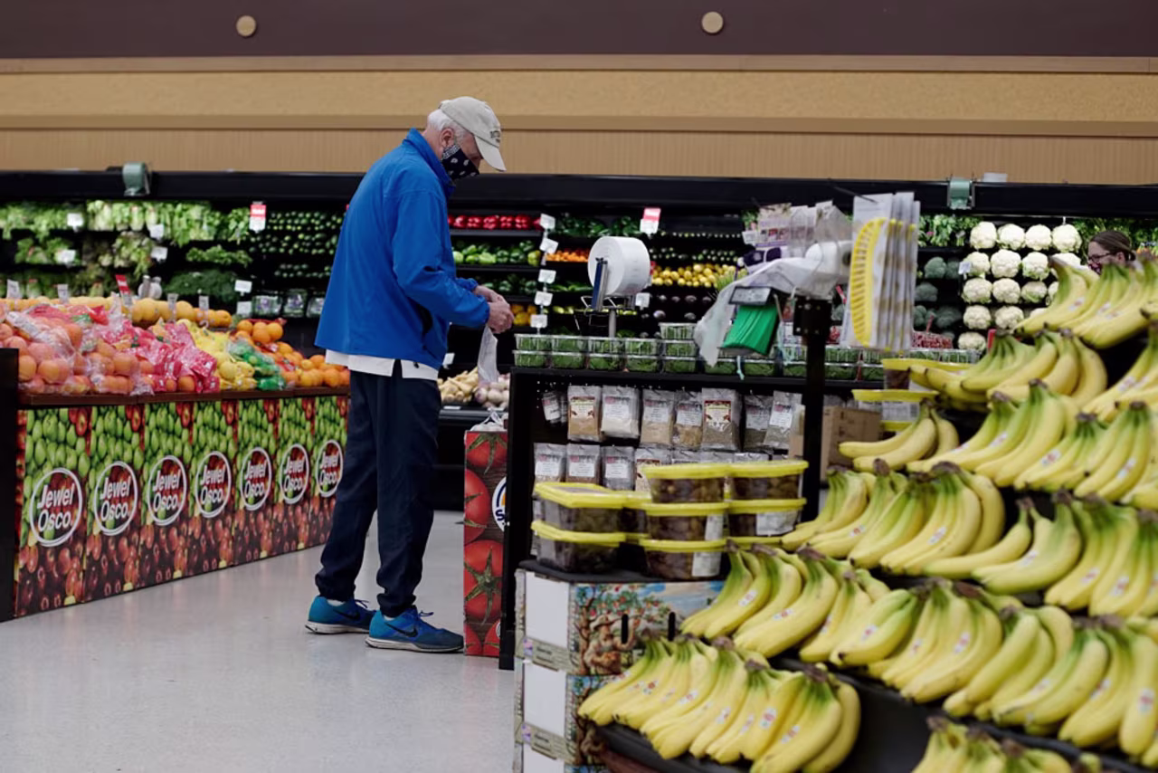 A shopper wears a mask and gloves as he shops at a grocery store in Mount Prospect, Illinois, on Wednesday, May 13.