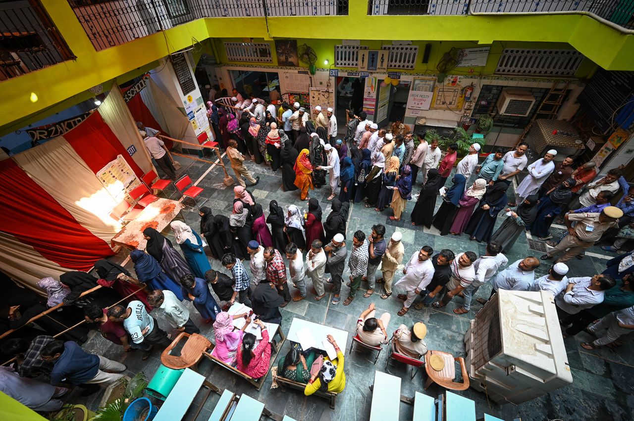 Voters stand in queues to cast their vote during the sixth phase of Loksabha Elections at a polling station at Jaffrabad in New Delhi on May 25.