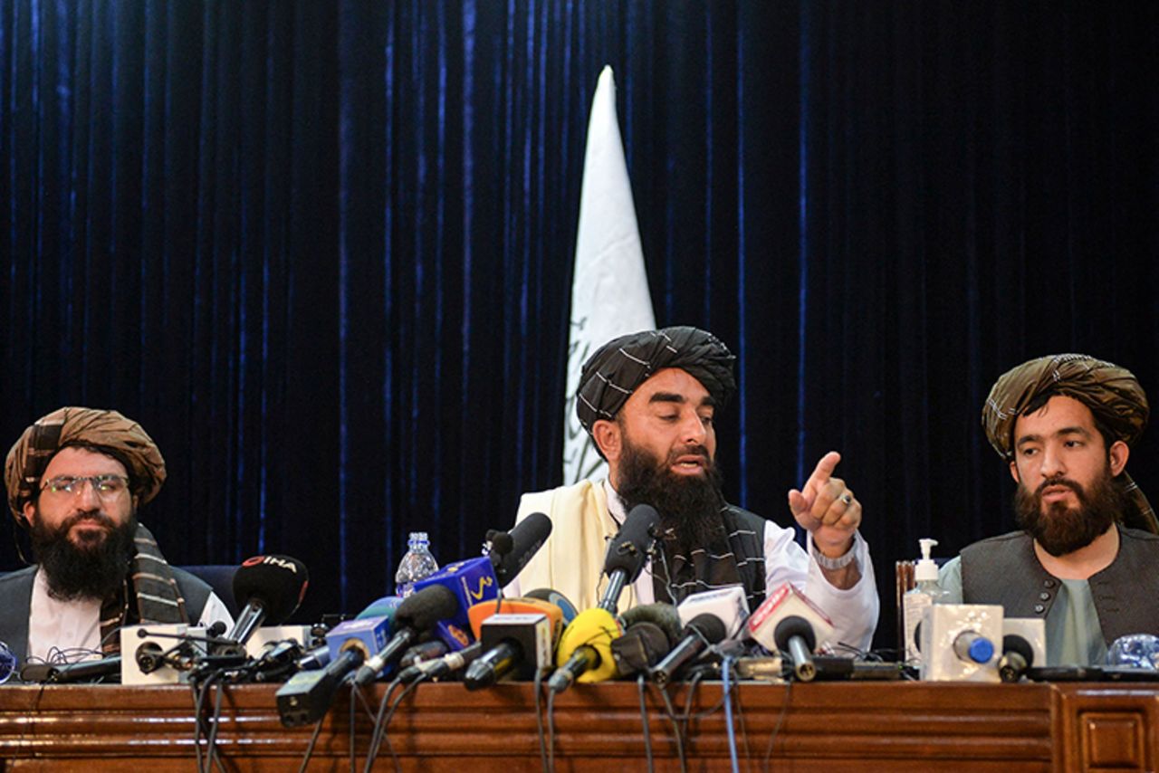 Taliban spokesperson Zabihullah Mujahid, center, gestures as he addresses the first press conference in Kabul onTuesday, August 17.