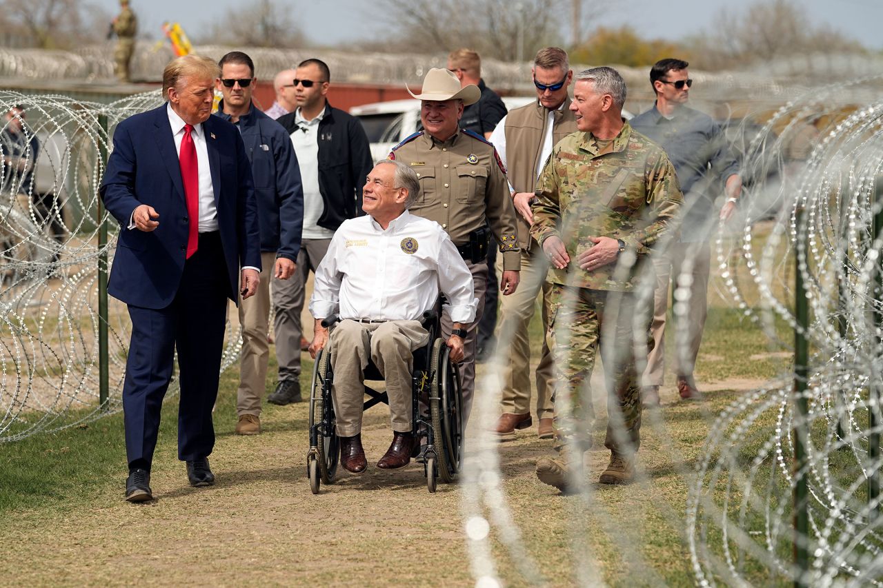 Former President Donald Trump talks with Texas Gov. Greg Abbott during a visit to the US-Mexico border on Thursday in Eagle Pass, Texas.