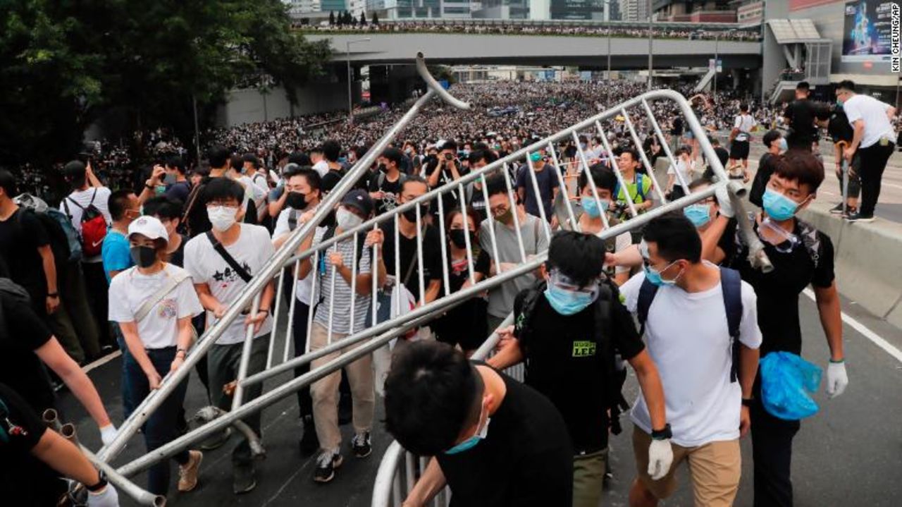 Protesters carry barricades as they march toward the Legislative Council in Hong Kong.