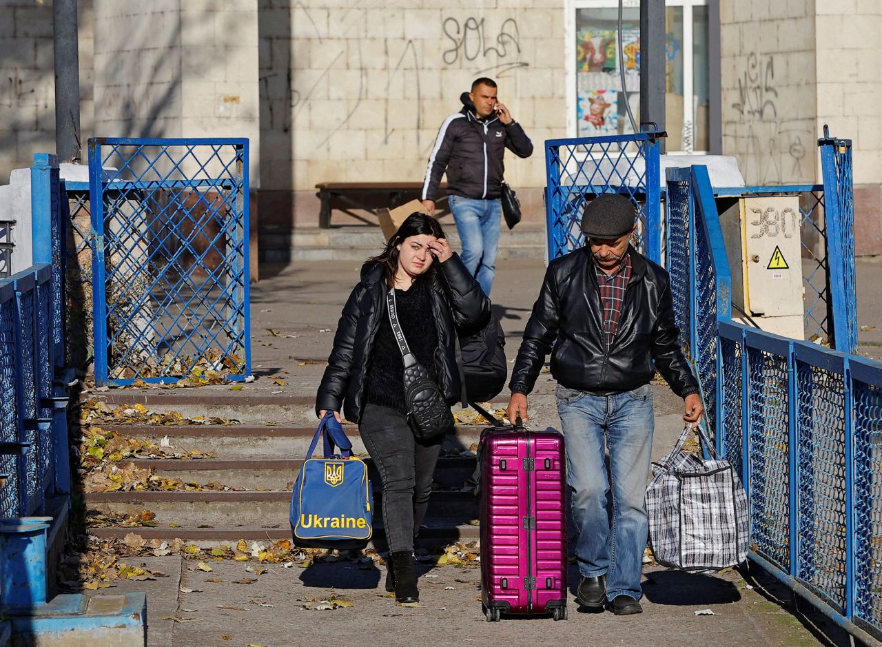 People walk to board a ferry during the evacuation of?Kherson, Ukraine, on October 31.