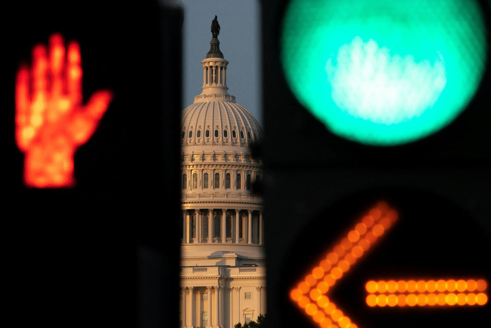 The dome of the US Capitol is seen through traffic signals in Washington, DC, on Monday, June 30.