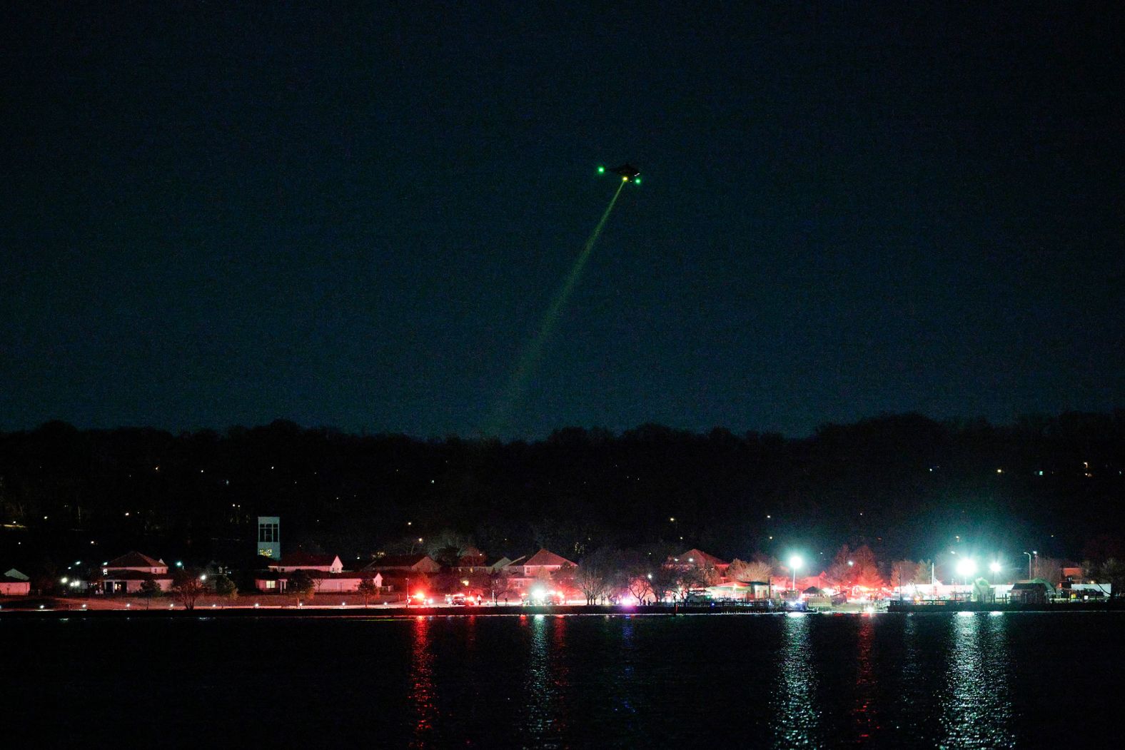 A helicopter assists with search-and-rescue operations after the collision on Wednesday.