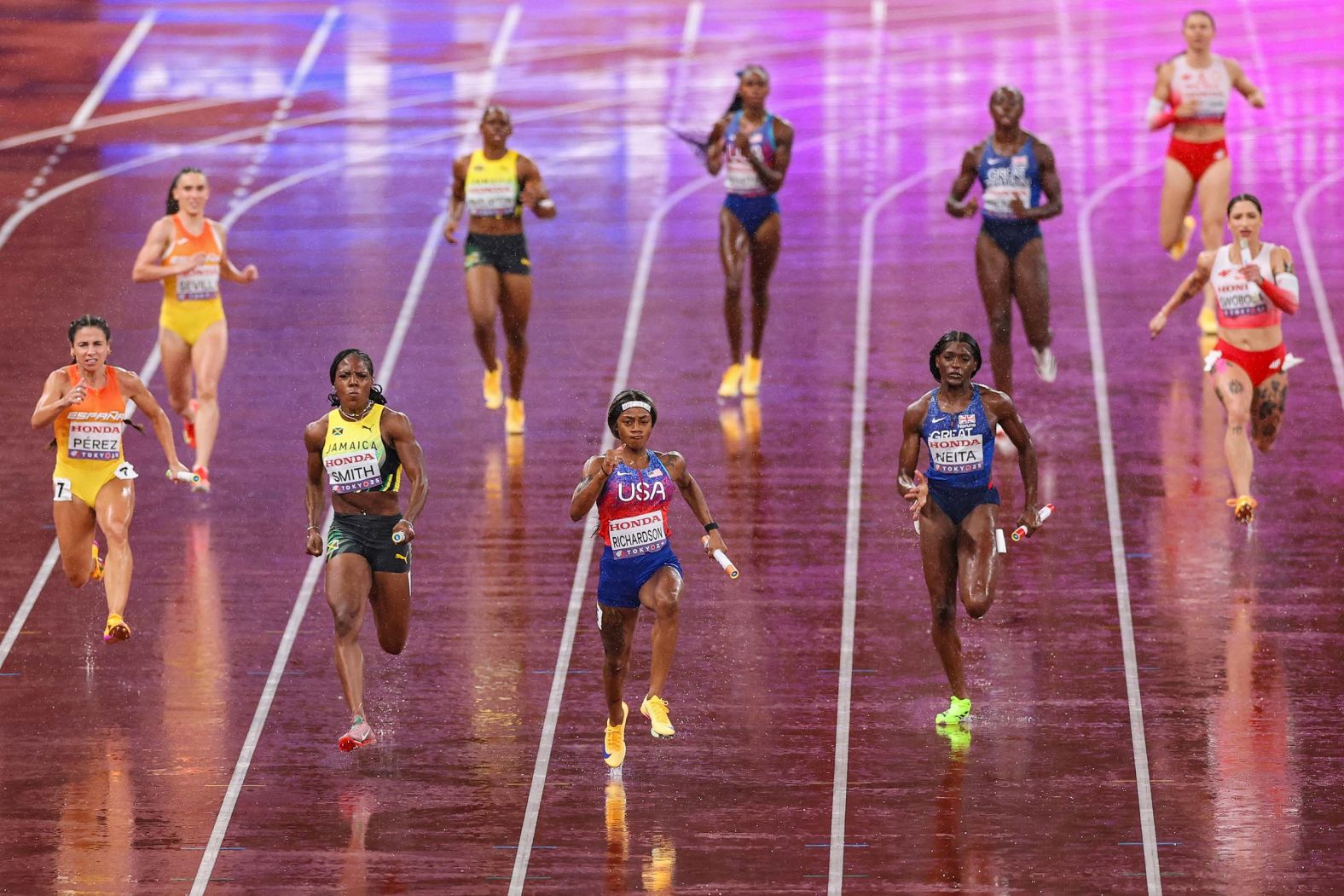US sprinter Sha’Carri Richardson, center, races in front of the pack during a 4x100 relay held at the World Athletics Championships in Tokyo on Sunday, September 21. The US team won the gold.