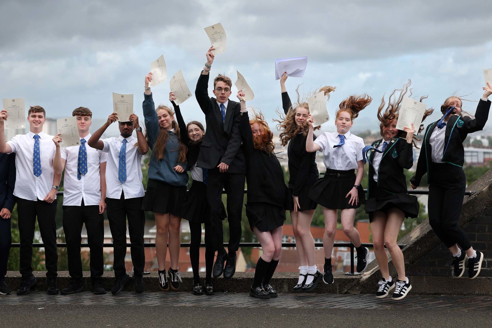 Students pose for a photograph after receiving exam results at Kings Park Secondary School in Glasgow, Scotland, on Tuesday, August 5.
