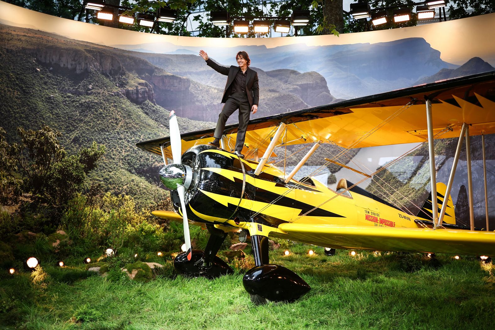 Actor Tom Cruise waves to an audience from the top of a plane in London as he attends the global premiere of “Mission: Impossible – The Final Reckoning” on Thursday, May 15.