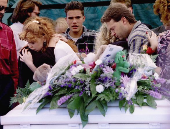Edye and Tony Smith are embraced beside the casket of their two young sons during a burial service in Oklahoma City on April 25, 1995. Chase and Colton Smith were 3 and 2 years old.