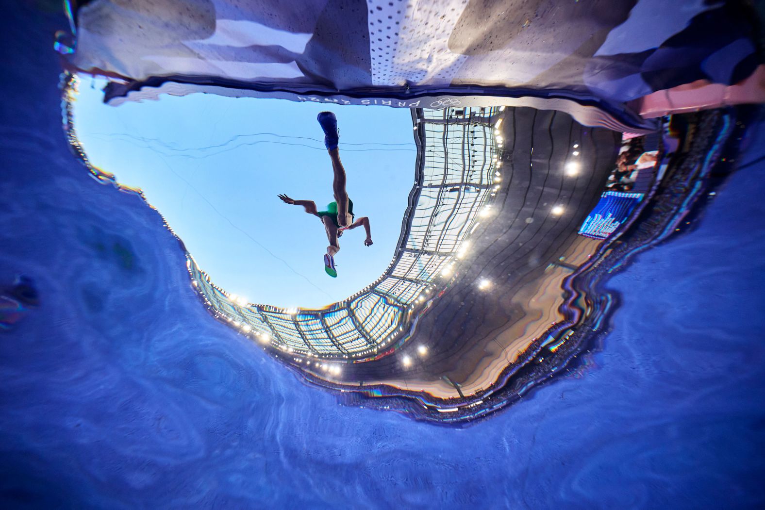 An athlete clears a water jump during an Olympic steeplechase race on Monday, August 5.