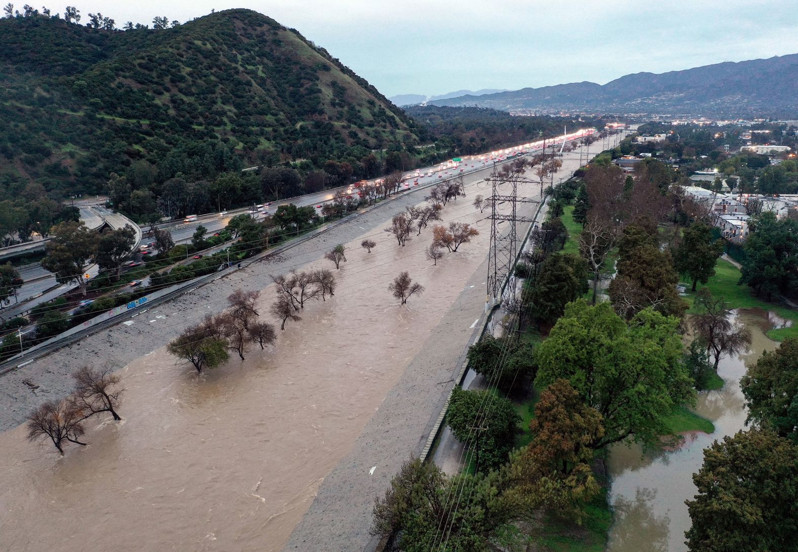 The Los Angeles River is swollen by storm runoff as an <a href="index.php?page=&url=https%3A%2F%2Fwww.cnn.com%2F2024%2F02%2F04%2Fus%2Fpineapple-express-storm-california-weather-monday%2Findex.html">intense, long-lasting atmospheric river</a> drenched Southern California with record-breaking rainfall on Monday, February 5.