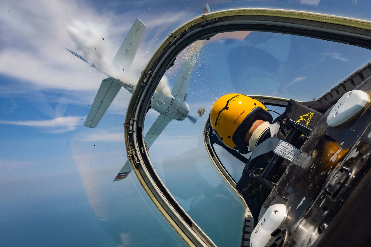 Pilot Robert Johnson, with the Trojan Phlyers Flight Demonstration Team, flies a North American T-28 Trojan above Gary, Indiana, on Thursday, August 8, ahead of the Chicago Air and Water Show.