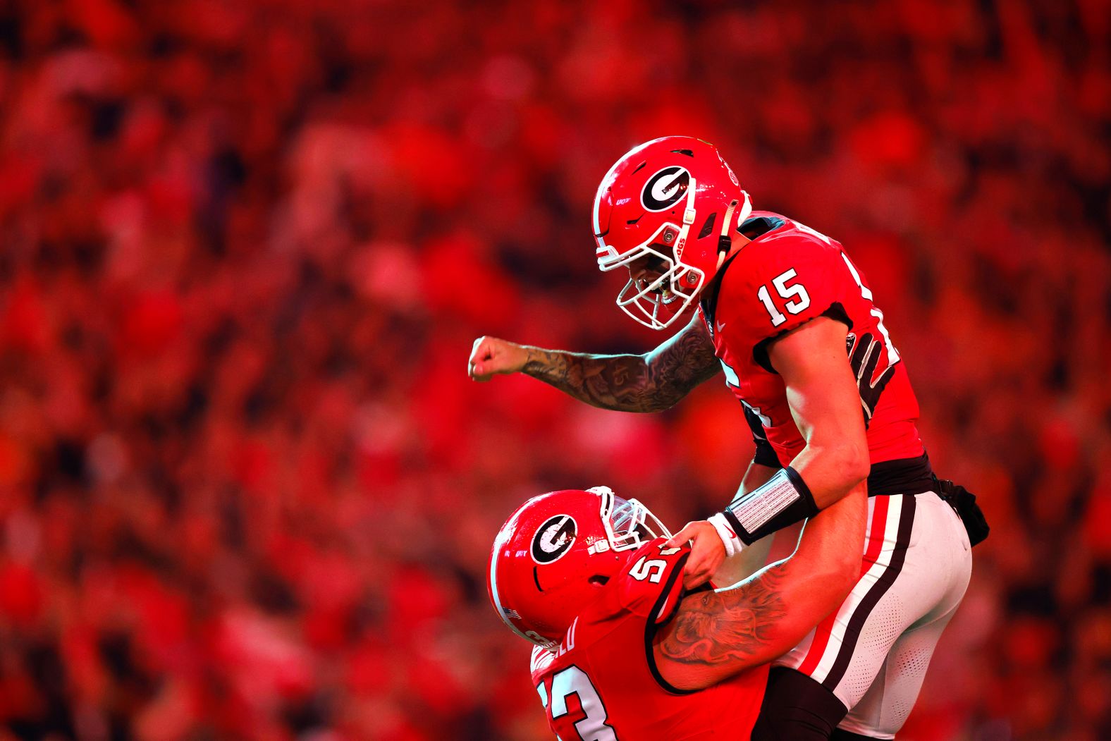 University of Georgia quarterback Carson Beck is lifted by teammate Dylan Fairchild after a touchdown against Tennessee on Saturday, November 16. Georgia won the game 31-17.