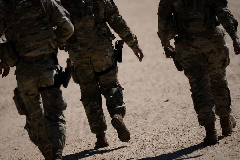 National Guardsmen patrol the National Mall in Washington, DC, on September 8. Hegseth pushed for guardsmen to be armed because he thought they looked weak without weapons, sources said.