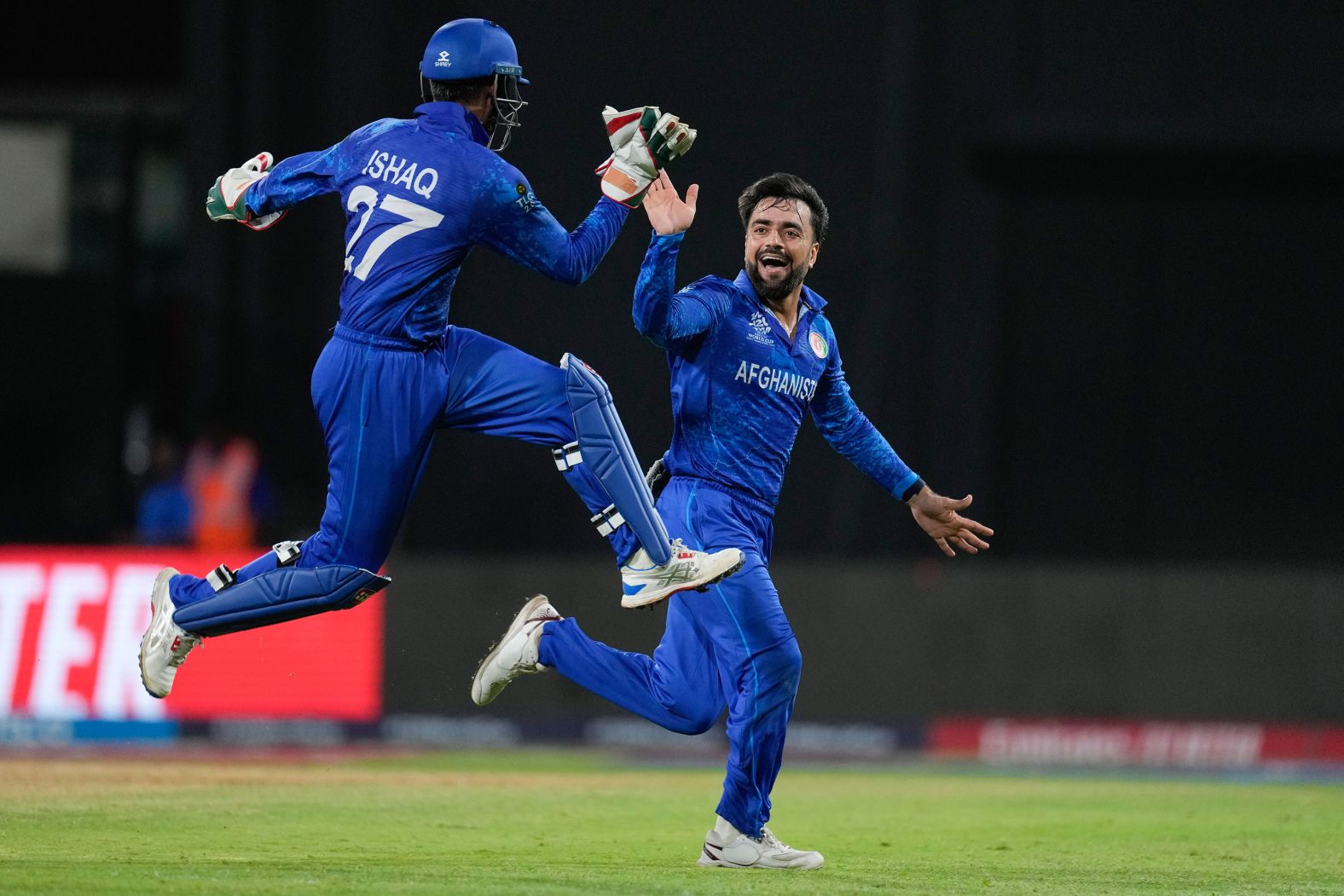 Afghanistan captain Rashid Khan is congratulated by teammate Mohammad Ishaq, left, after dismissing Bangladesh's Rishad Hossain during cricket’s T20 World Cup on Monday, June 24. Afghanistan would go on to make the semifinals of the tournament, <a href="index.php?page=&url=https%3A%2F%2Fwww.cnn.com%2F2024%2F06%2F26%2Fsport%2Fafghanistan-historic-semifinal-t20-cricket-world-cup-spt-intl%2Findex.html">a historic success for the team</a>, before losing to South Africa.