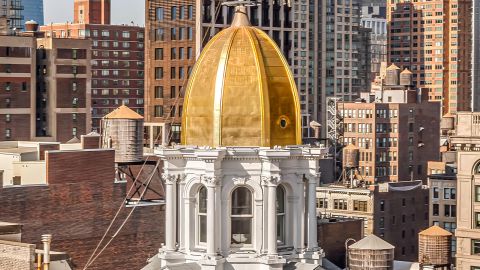 A rare penthouse inside a glimmering gold dome is up for sale in New York City.