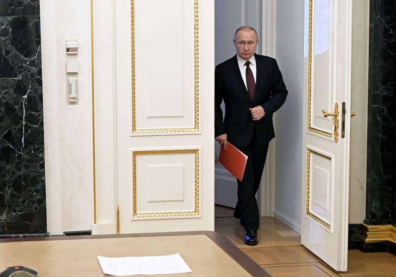 Russian President Vladimir Putin enters a room before a meeting with members of his security council in Moscow on February 25.