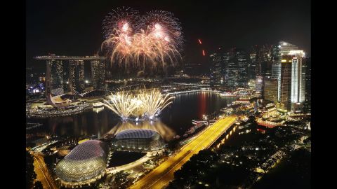 Fireworks explode above Singapore's financial district at the stroke of midnight.