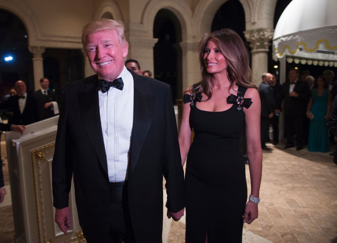 President-elect Donald Trump arrives with his wife, Melania, for a New Year's Eve party December 31, 2016 at Mar-a-Lago in Palm Beach, Florida.