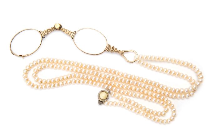 This folding lorgnette, embellished with pearls, comes from the early-1900s in Central Europe.