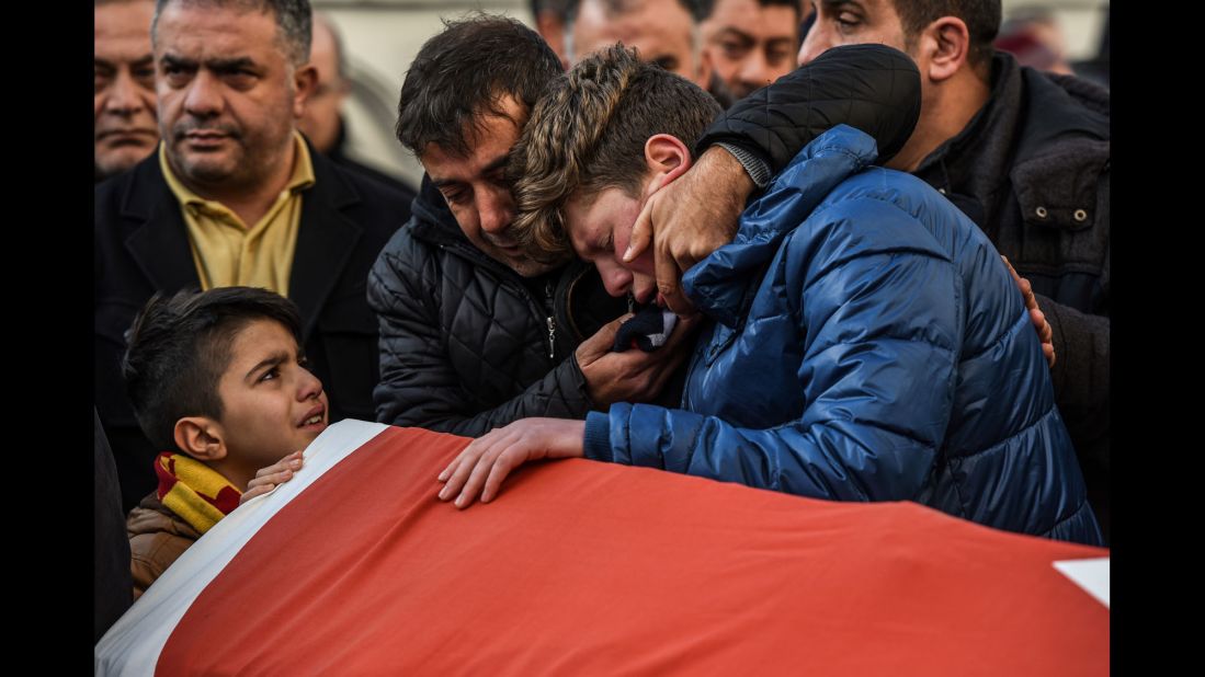 Relatives of Ayhan Arik, one of the victims of the attack, cry during a funeral ceremony in Istanbul on January 1.
