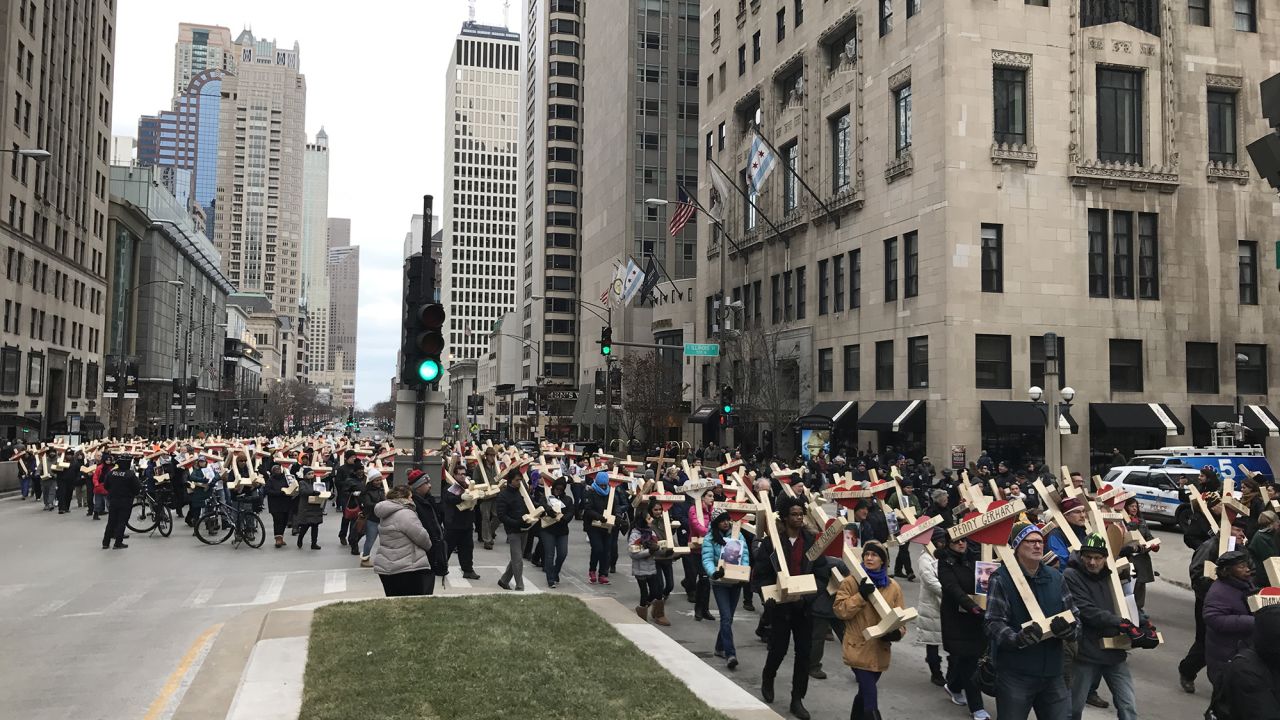 On New Year's Eve, people carried nearly 800 wooden crosses bearing the names of those killed in Chicago in 2016. 