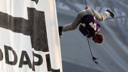 MINNEAPOLIS, MN - JANUARY 1: A protestor wearing a Brett Farve jersey dangles upside down above Minnesota Vikings and Chicago Bears football game on January 1, 2017 at US Bank Stadium in Minneapolis, Minnesota. Two protesters hung a banner in opposition to the Dakota Access Pipeline from the rafters of the stadium in the second quarter of the game. (Photo by Adam Bettcher/Getty Images)