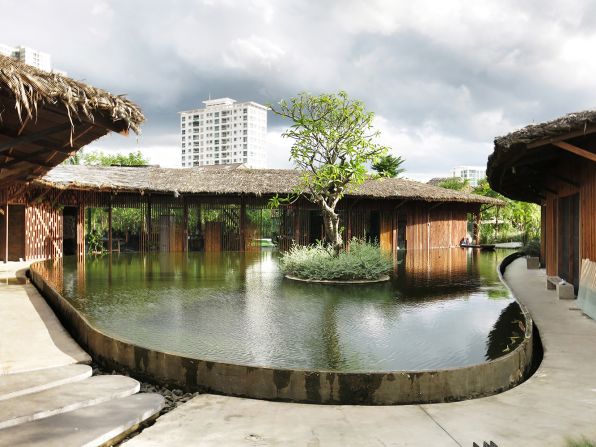 The T3 team designed its own Green Office building in downtown Saigon using bioclimatic principles. The architecture firm enjoys wood fixtures, a roof made of palm leaves, overhanging eaves to protect from the city's blazing sun, and a tranquil pond as a center piece.