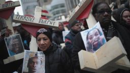 CHICAGO, IL - DECEMBER 31:  Residents, activists, and friends and family members of victims of gun violence march down Michigan Avenue carrying nearly 800 wooden crosses bearing the names of people murdered in the city in 2016 on December 31, 2016 in Chicago, Illinois. Nearly 800 people have been murdered in the city this year and more than 4000 shot as the city copes with its most violent year in two decades.  (Photo by Scott Olson/Getty Images)