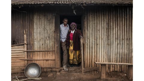 Muiruri with his grandmother Ruth, after whom he was originally named, outside the kitchen of his family home.