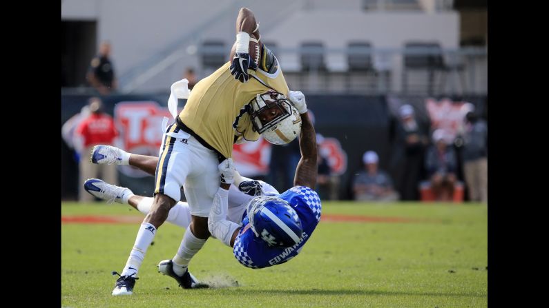 Georgia Tech's Qua Searcy is tackled by Kentucky's Mike Edwards during the TaxSlayer Bowl on Saturday, December 31. Georgia Tech won 33-18.