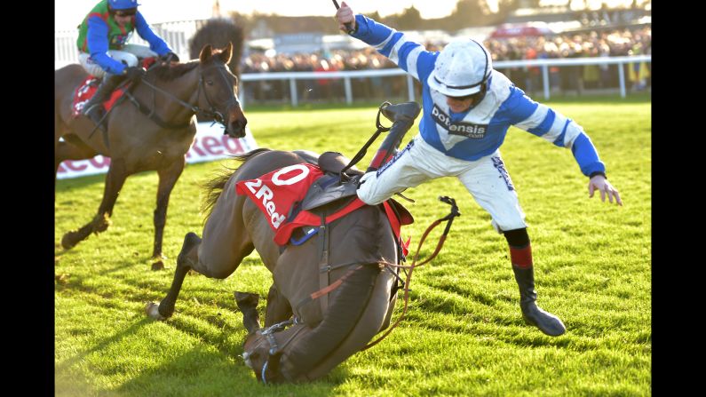 Sam Twiston-Davies falls off his horse Frodon as they compete in a steeplechase in Kempton, England, on Monday, December 26.