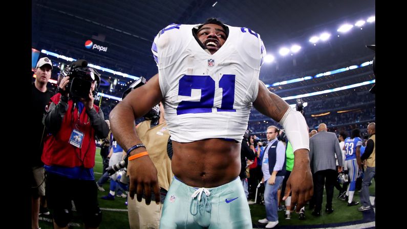 Dallas running back Ezekiel Elliott struggles to take off his jersey and shoulder pads after a home win against Detroit on Monday, December 26. The Cowboys enter the NFL playoffs with home-field advantage in their conference.