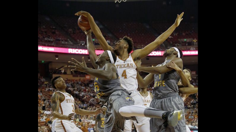 Texas' James Banks blocks a shot by Kent State's Jimmy Hall during a college basketball game in Austin, Texas, on Tuesday, December 27.